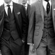 Three men in grey tweed three-piece suits with waistcoats and ties, black and white photo
