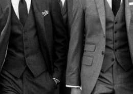 Three men in grey tweed three-piece suits with waistcoats and ties, black and white photo