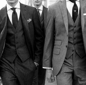 Three men in grey tweed three-piece suits with waistcoats and ties, black and white photo